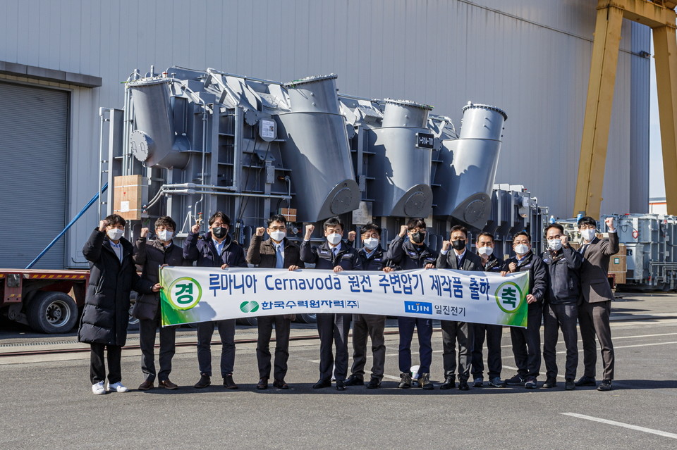 한수원과 일진전기 직원들이 18일 일진전기 공장에서 루마니아 체르나보다원전으로 보낼 주변압기 제작을 완료하고 출하하며 기념촬영을 하고 있다. (사진=한수원 제공)
