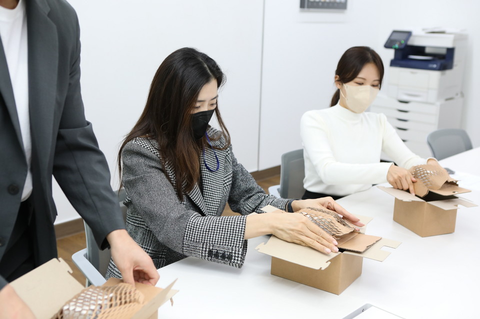 조현민 미래성장전략 및 마케팅 총괄 사장이 ㈜한진 및 에코라이프패키징㈜ 임직원과 함께 친환경 패키징 ‘그린와플’로 택배를 포장해보고 제품을 시연하는 시간을 가지고 있다. (사진=㈜한진 제공)