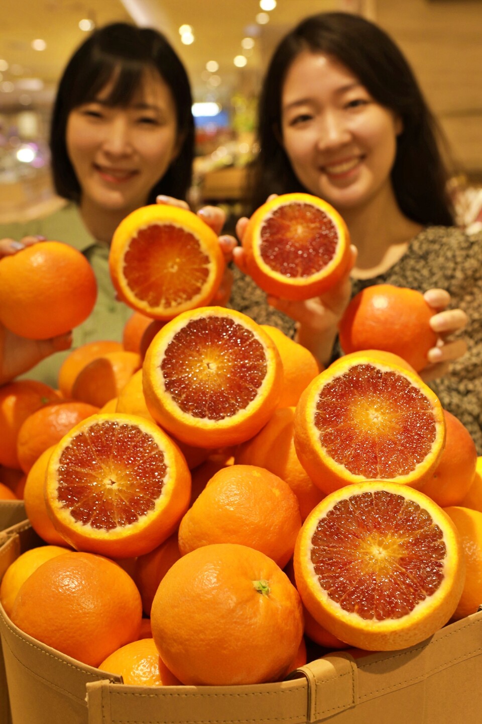 롯데백화점 본점 지하 1층 청과매장에서 블러드 오렌지를 들고 있는 모습. (사진=롯데백화점 제공)